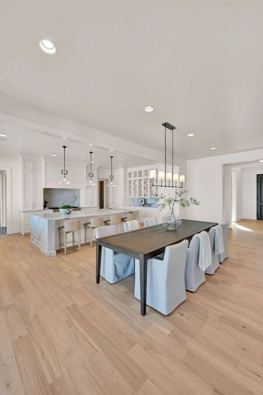 There is a dining room table and chairs in the middle of the room.