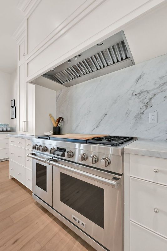 A kitchen with a stainless steel stove and oven.