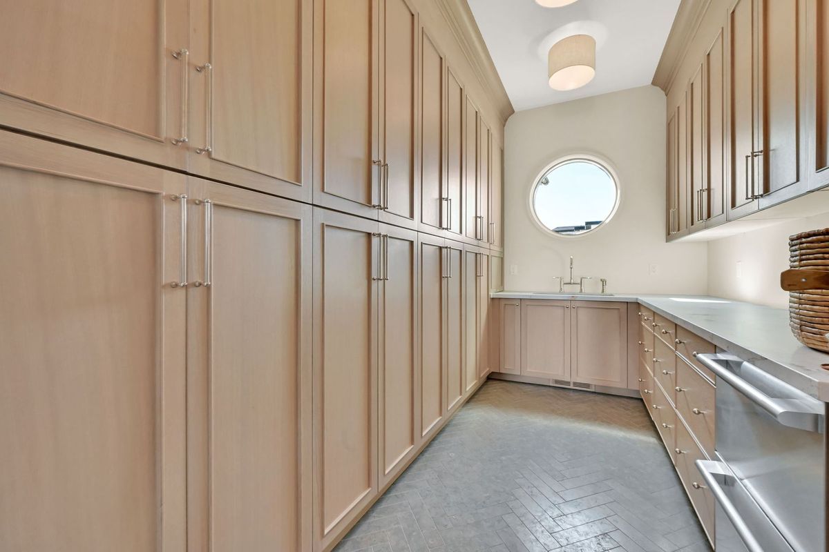 A kitchen with lots of cabinets and a sink