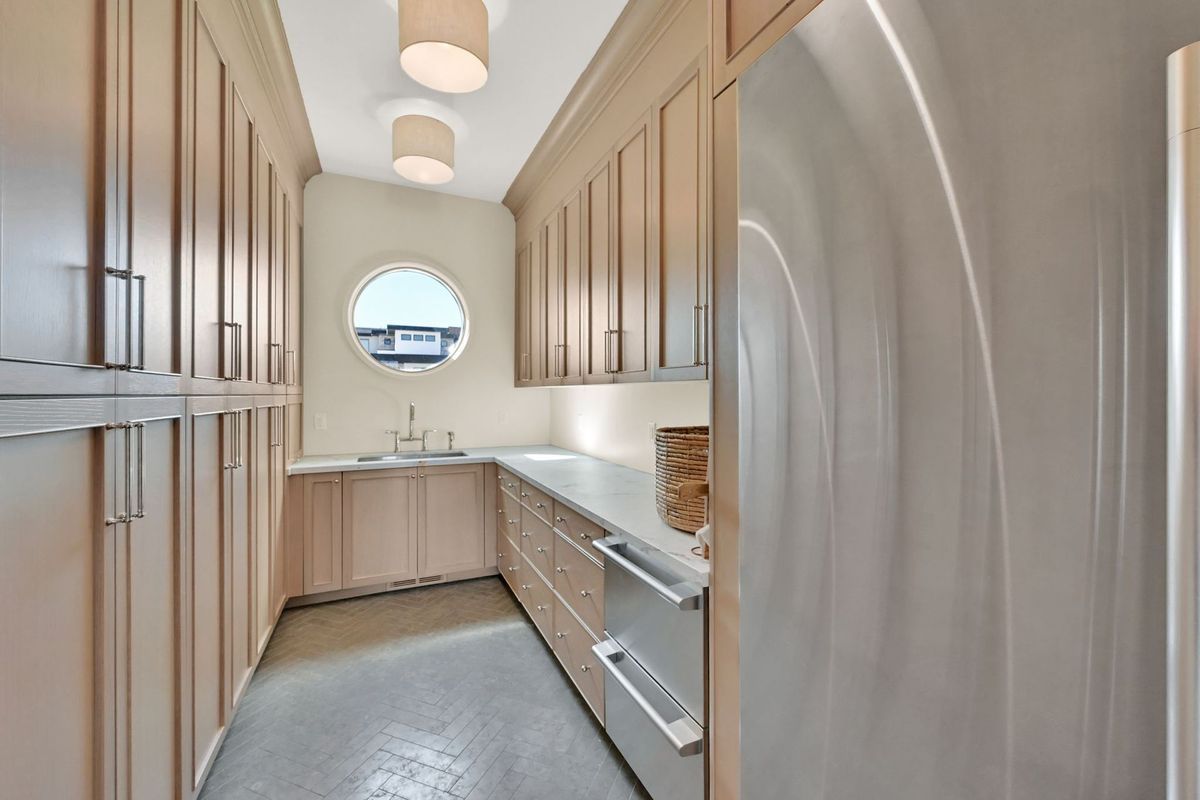 A kitchen with stainless steel appliances and wooden cabinets