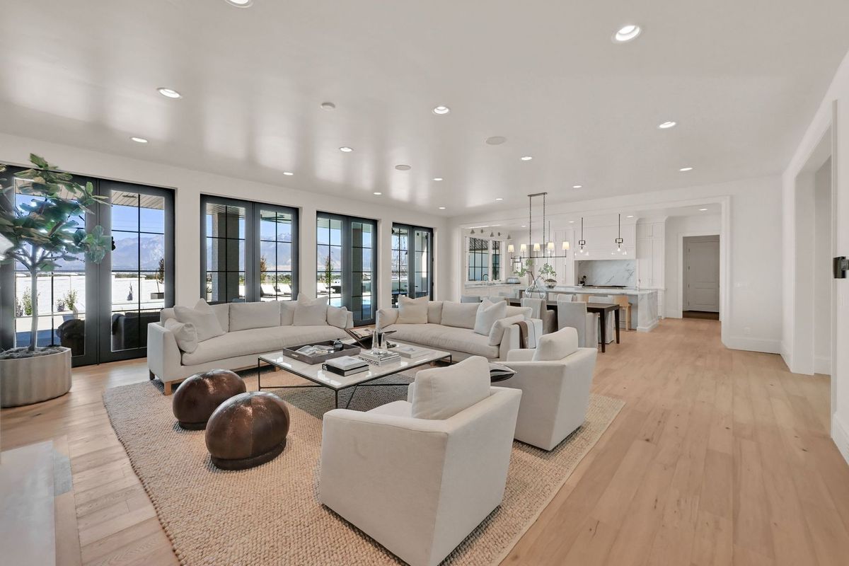 A living room with a couch , chairs , and a coffee table.