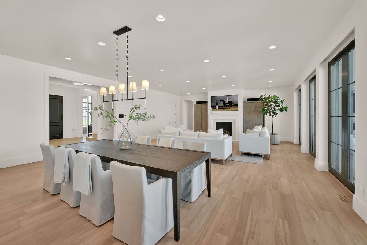 There is a dining table and chairs in the middle of the room.