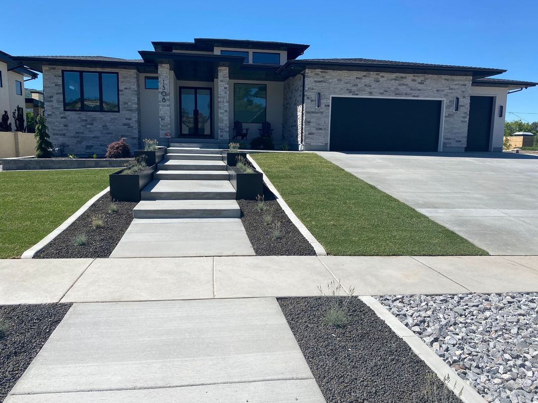 A large house with a concrete walkway leading to it