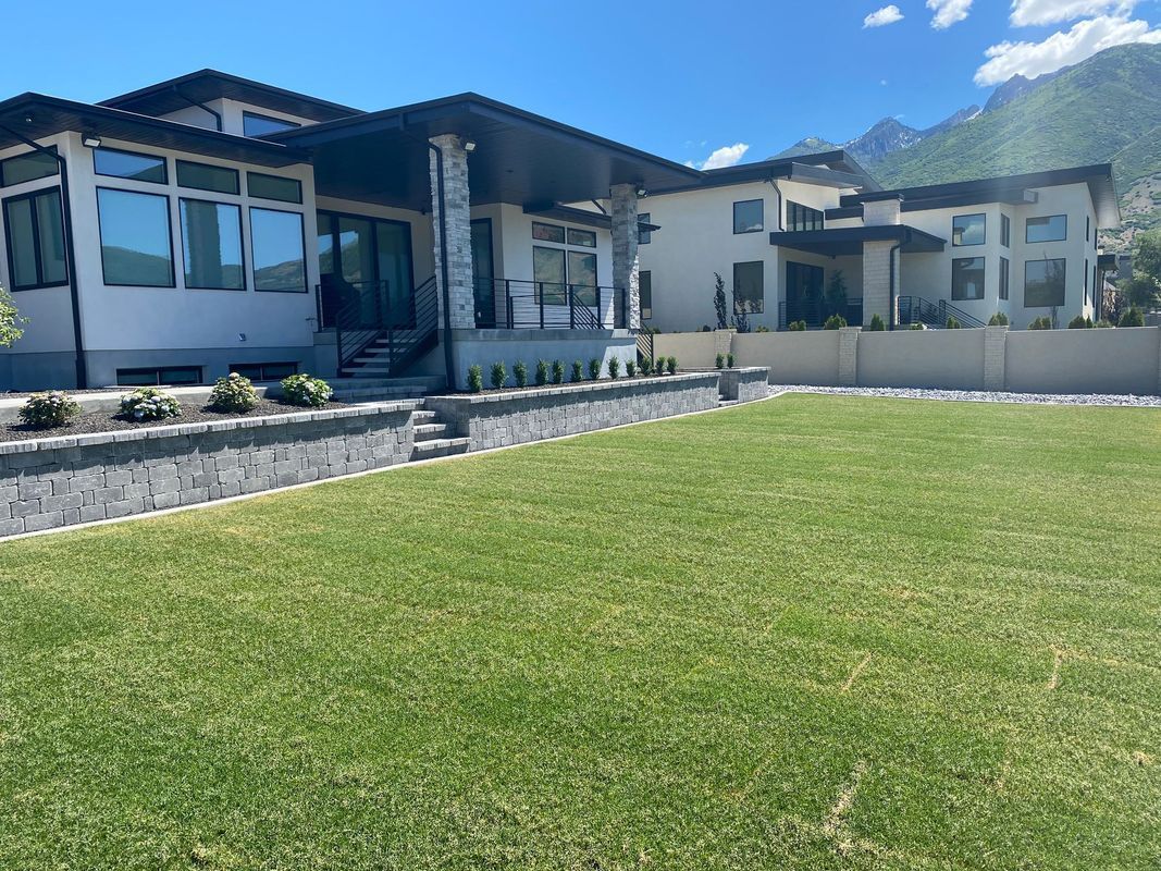 A large house with a large lawn in front of it.