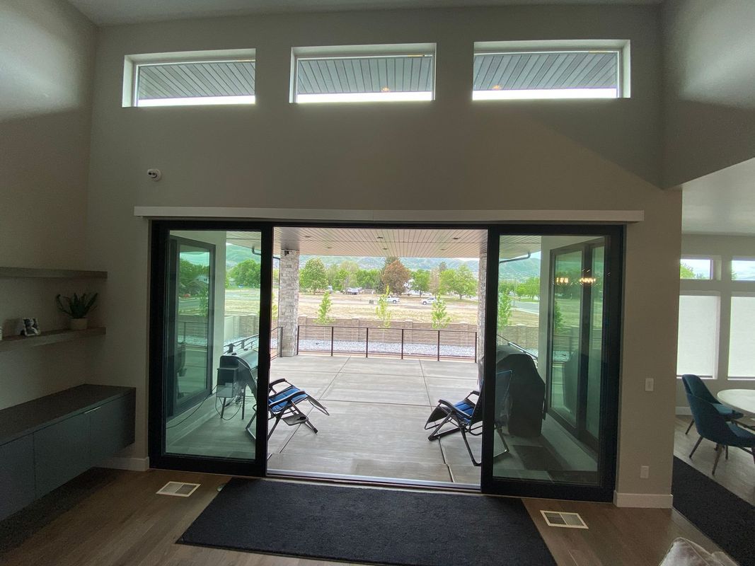 A living room with sliding glass doors leading to a patio.