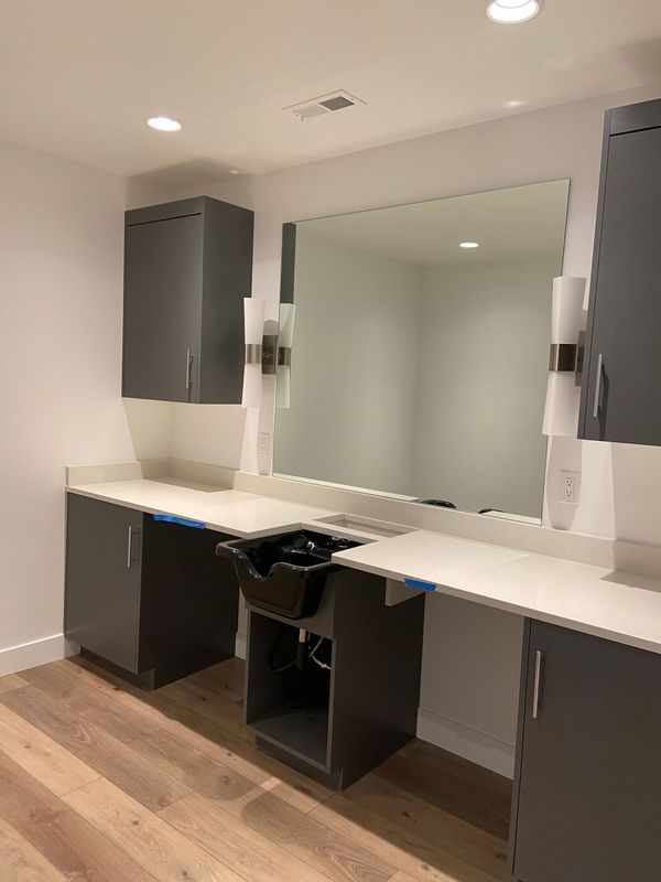 A bathroom with a sink and a large mirror.