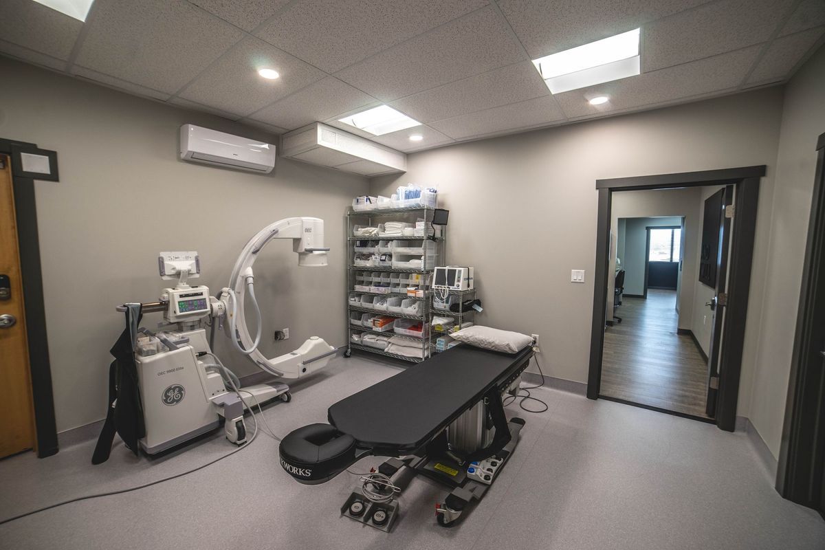 A hospital room with a table and a ct scan machine.