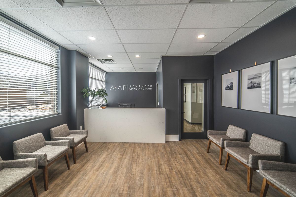 A waiting room with chairs and a counter in a dental office.