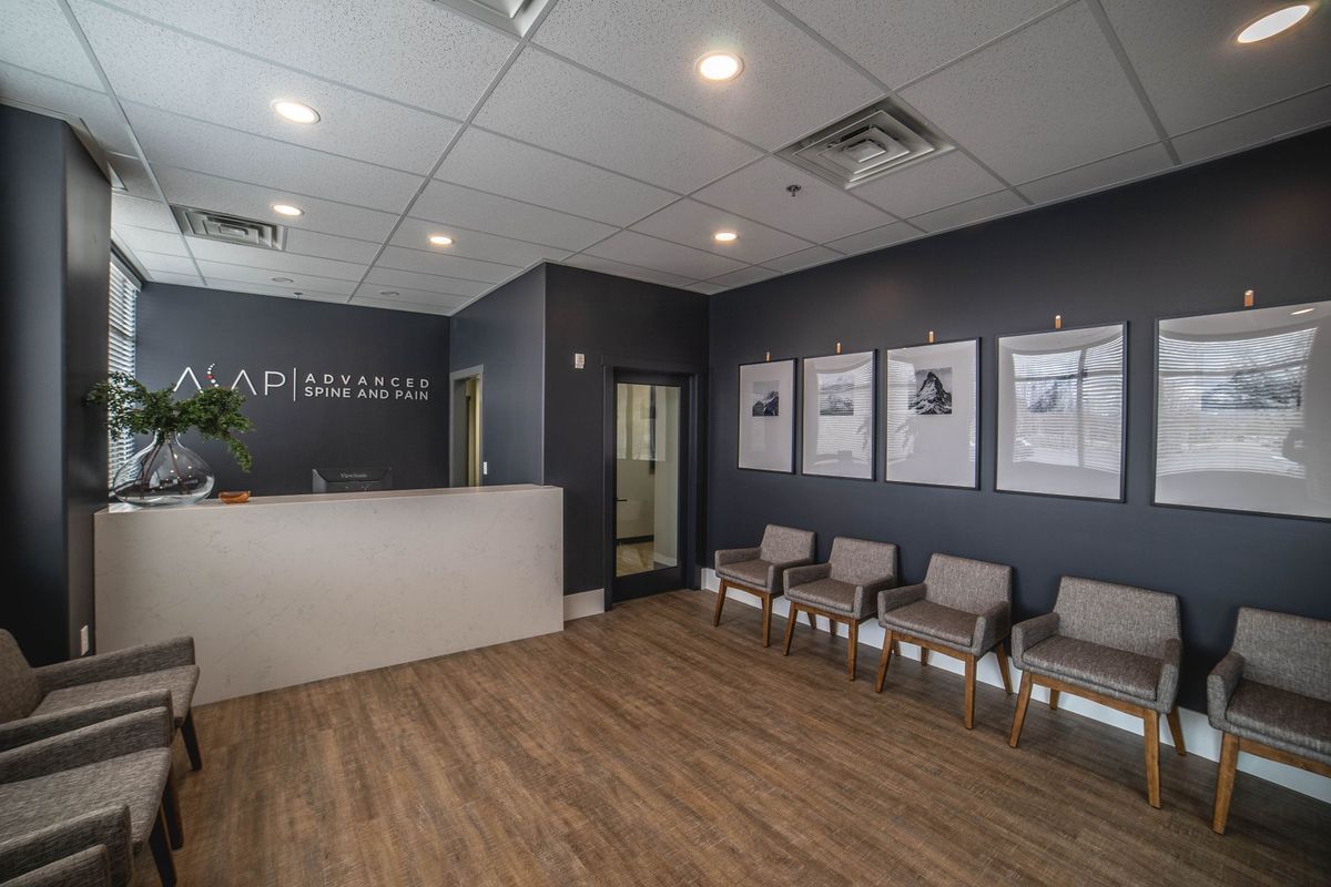 A waiting room with chairs and a counter in a dental office.