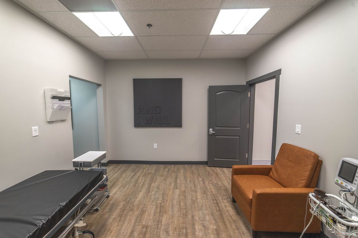 A room with a couch and a bed in it