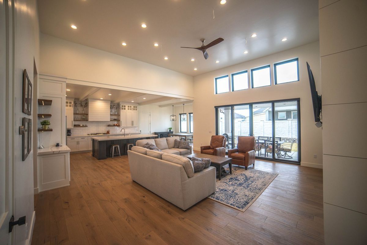 A living room filled with furniture and a ceiling fan.
