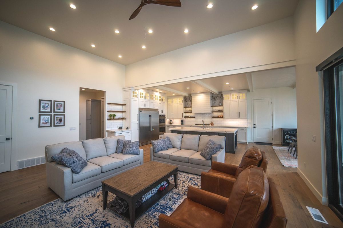 A living room filled with furniture and a ceiling fan.