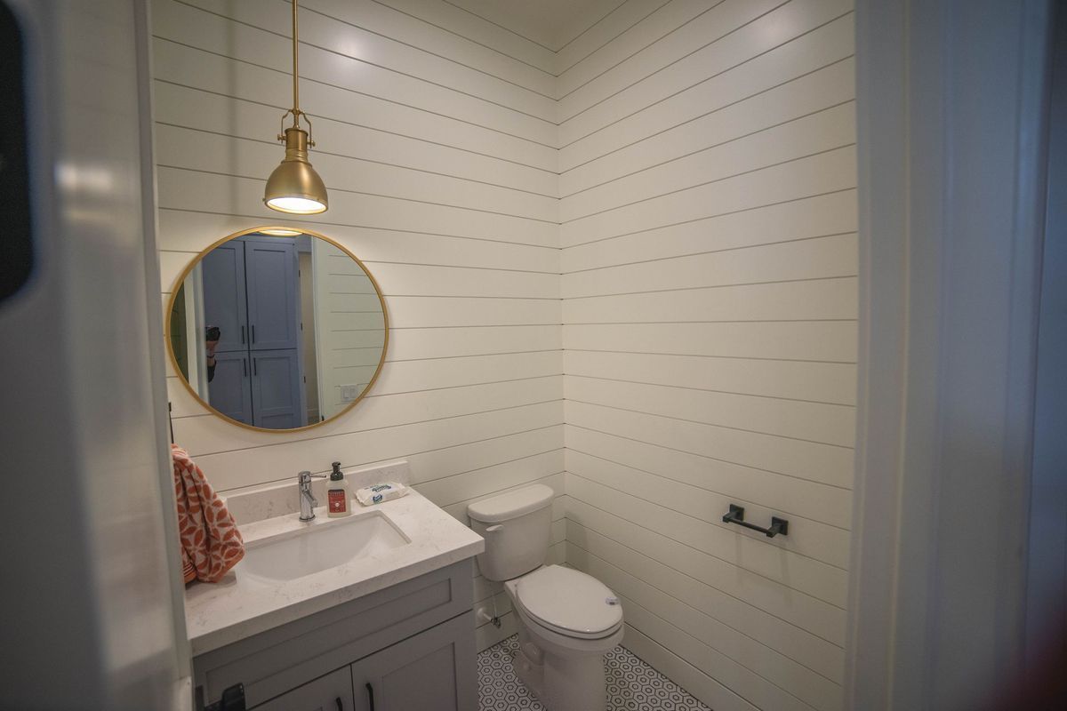 A bathroom with a sink , toilet and mirror.