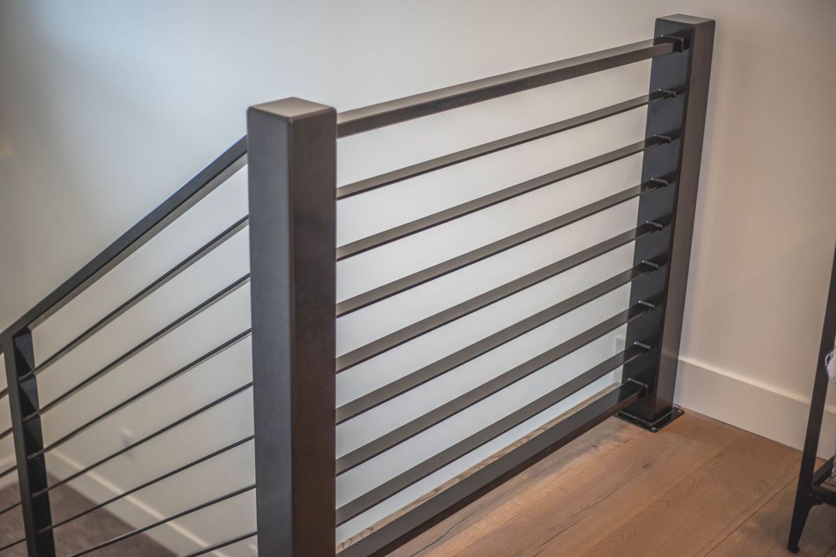 A close up of a railing on a staircase in a house.