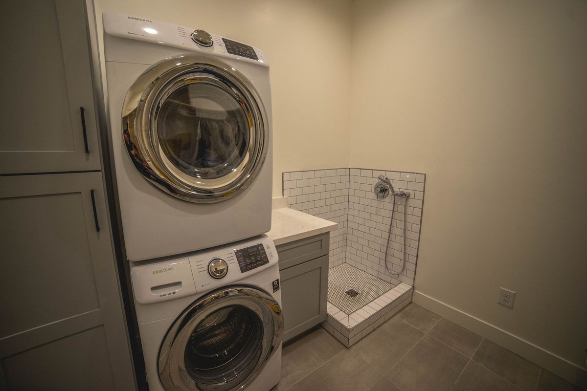 A laundry room with a washer and dryer stacked on top of each other.