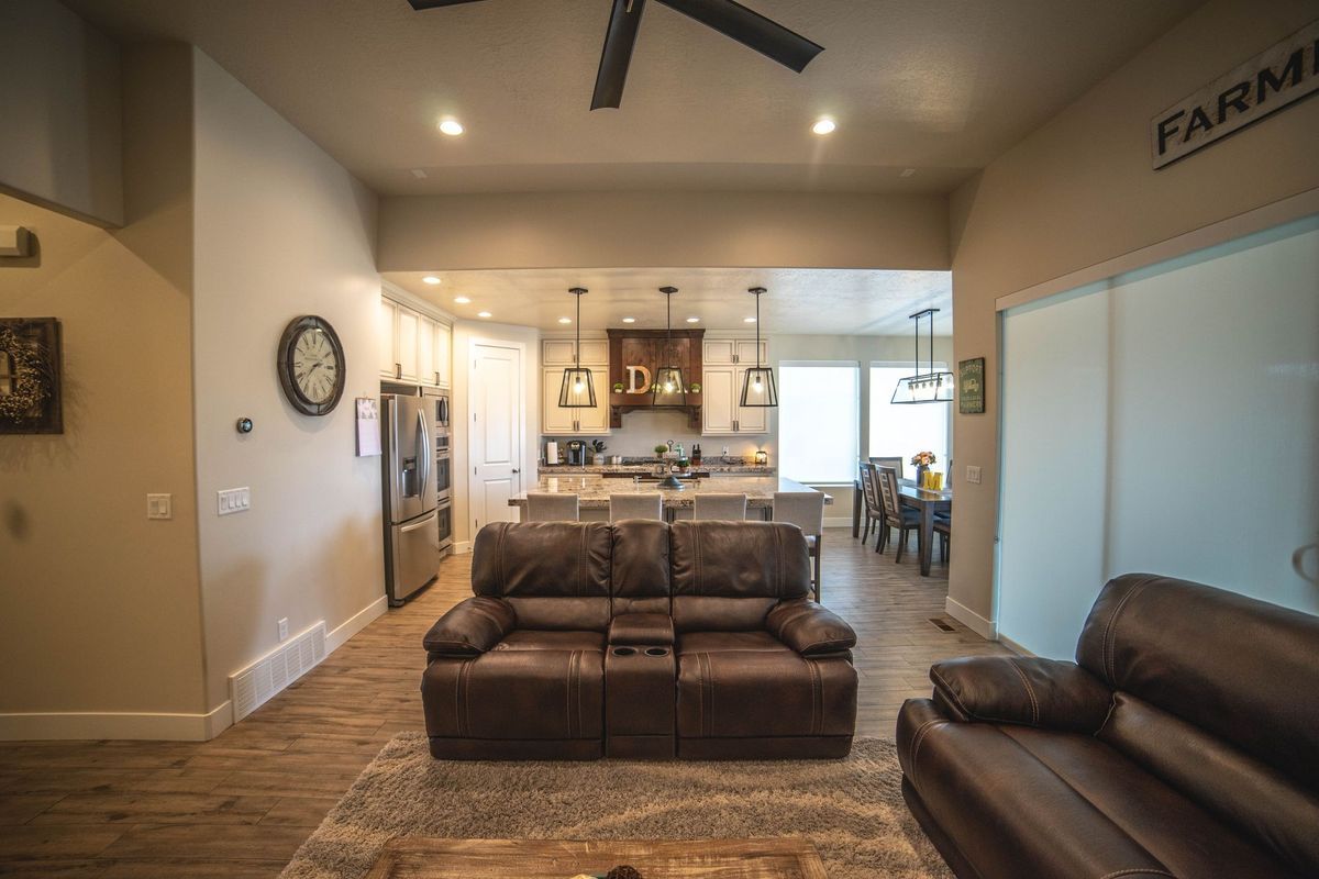 A living room filled with furniture and a ceiling fan.
