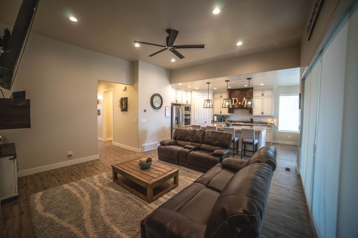 A living room filled with furniture and a ceiling fan.