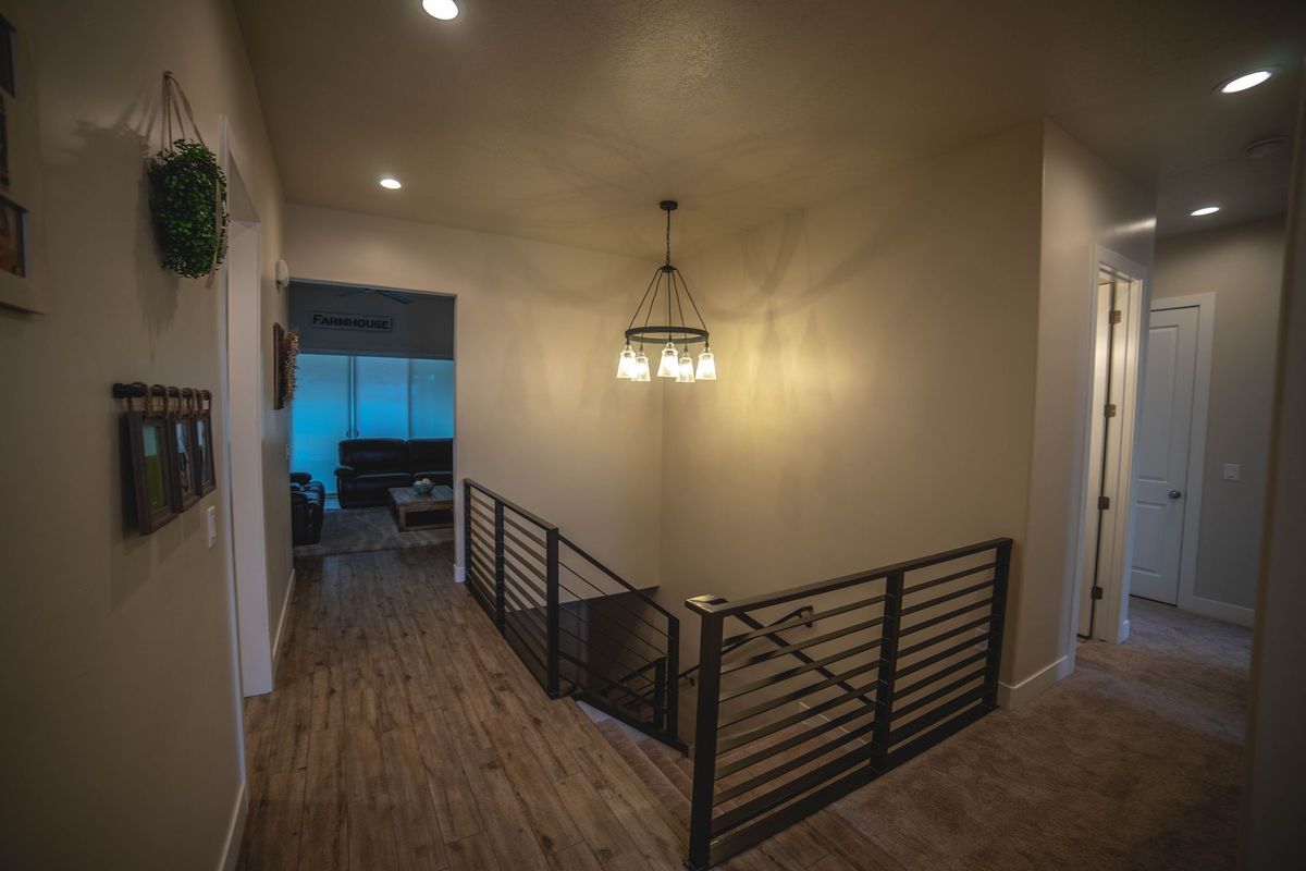A hallway with stairs leading up to the second floor of a house.