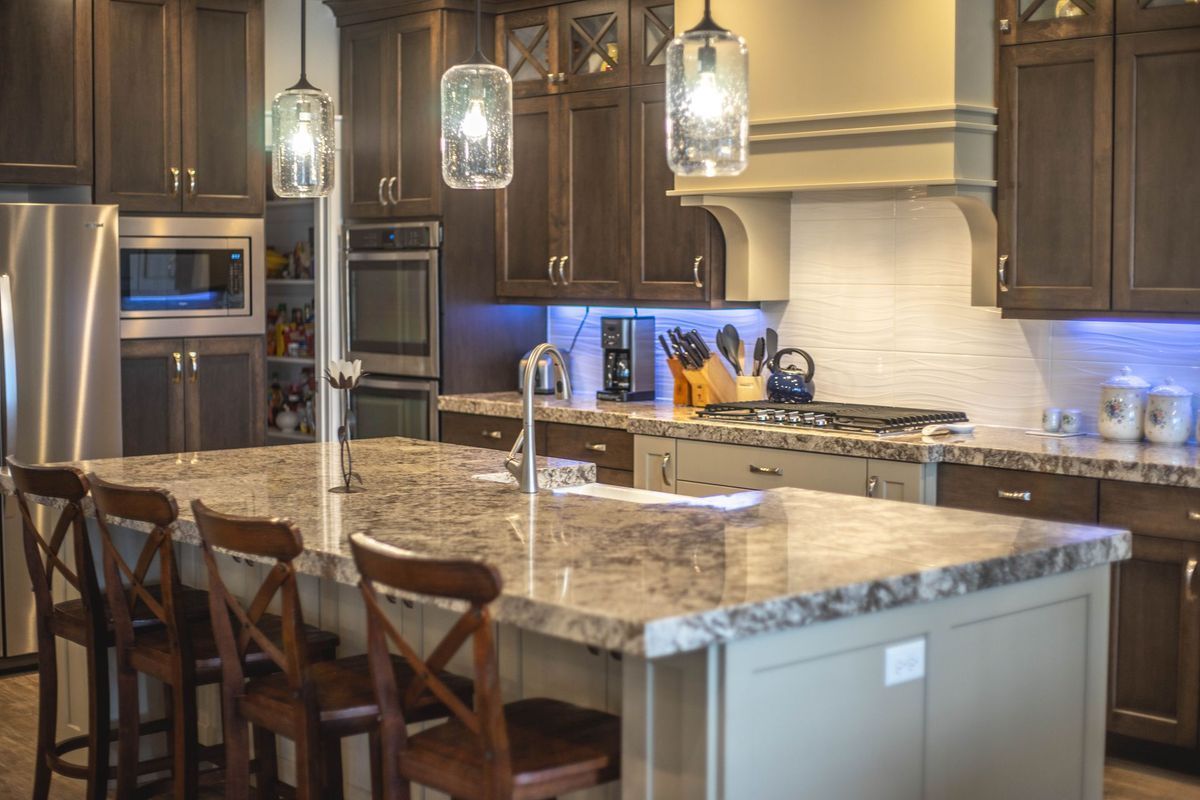 A kitchen with stainless steel appliances and granite counter tops.