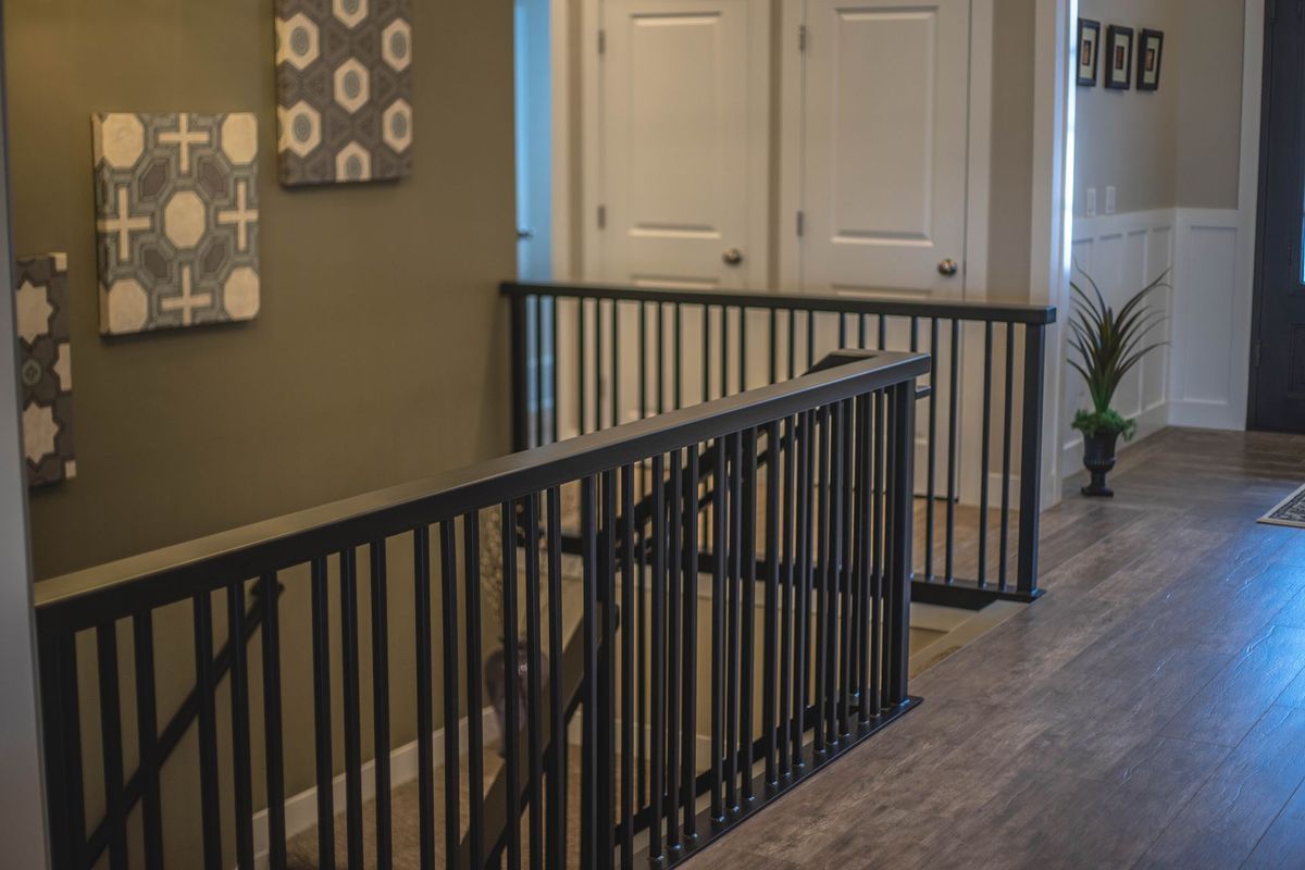 A staircase with a black railing in a house.