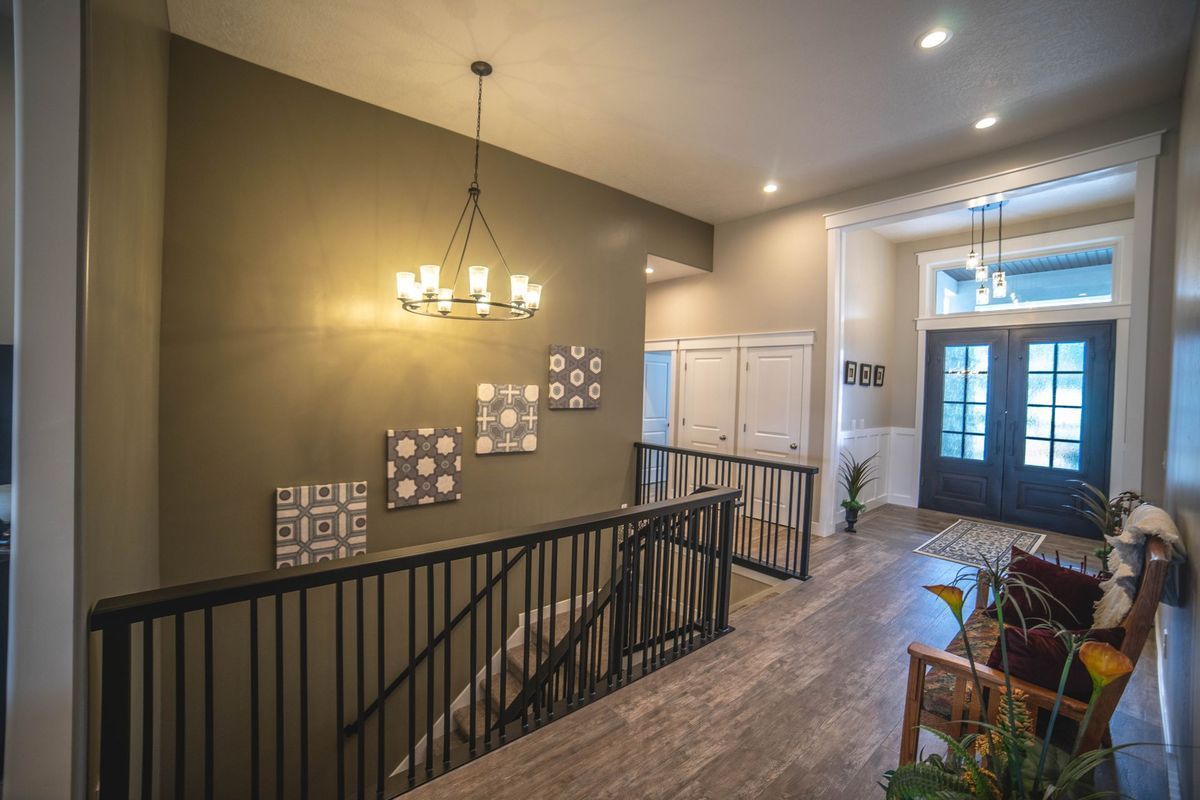A hallway with stairs leading up to the second floor of a house.