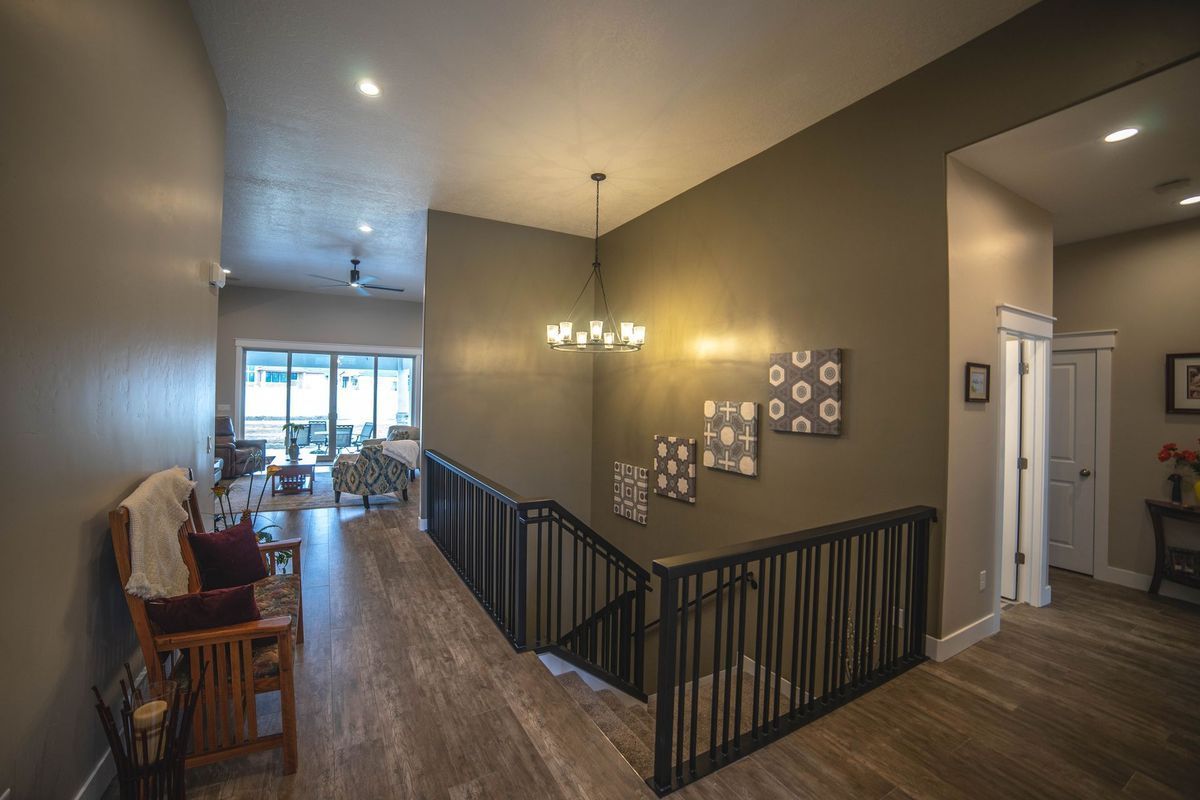 A hallway with stairs leading up to the second floor of a house.