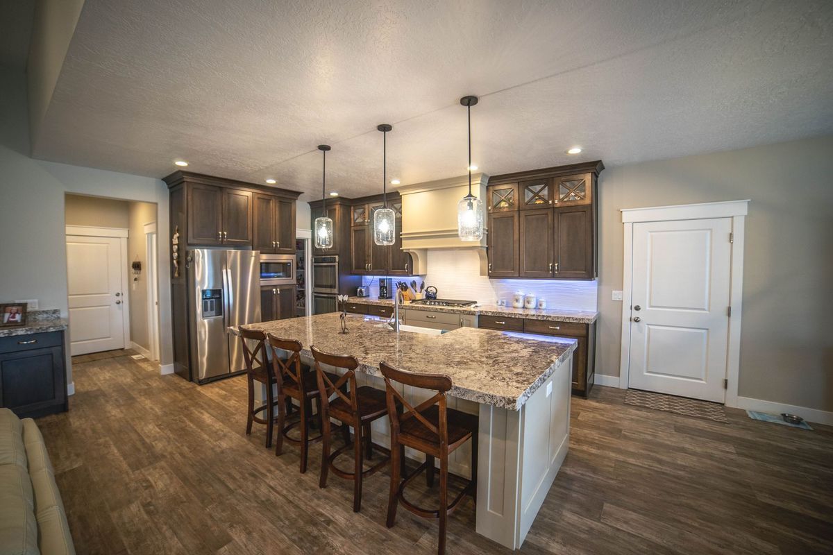 A kitchen with stainless steel appliances and granite counter tops.
