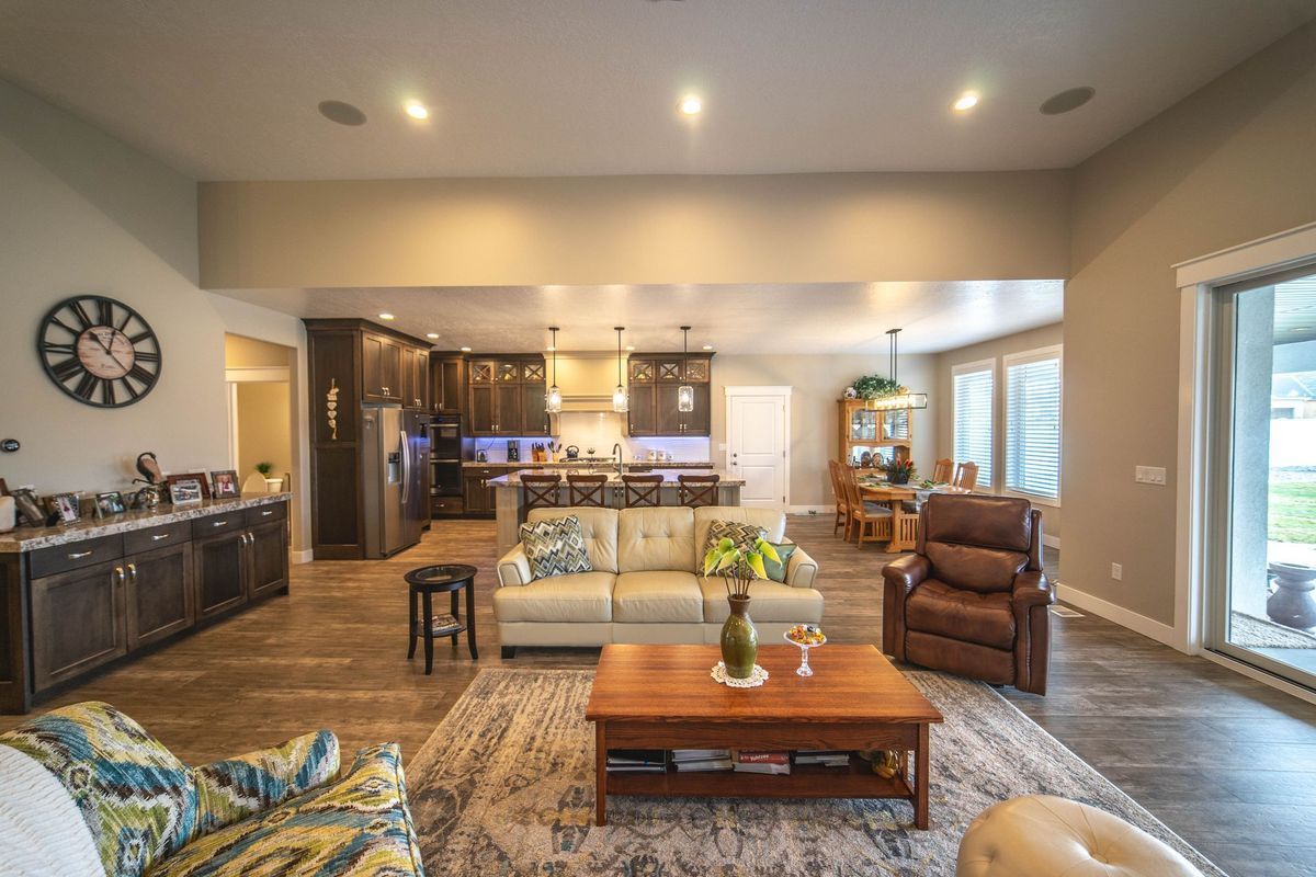 A living room filled with furniture and a clock on the wall.