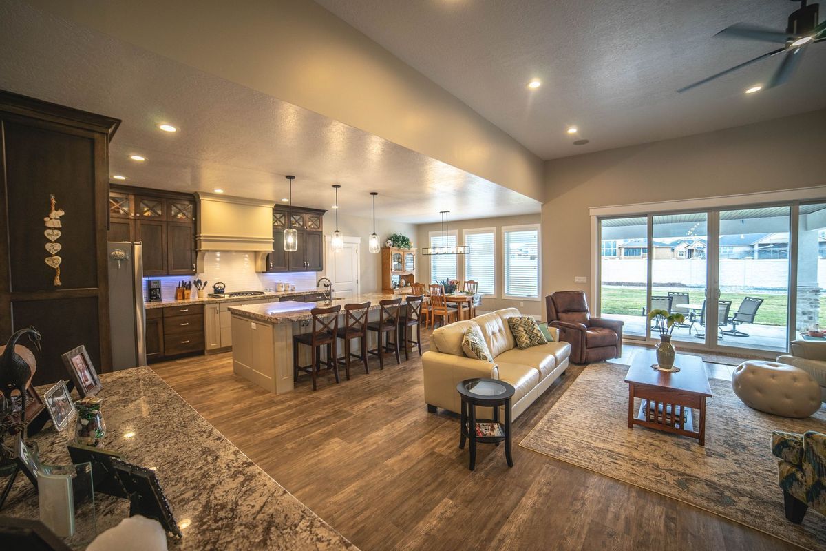 A living room filled with furniture and a ceiling fan.