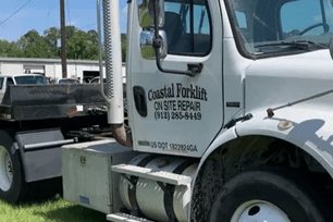 White truck with "Coastal Forklift On Site Repair" logo.