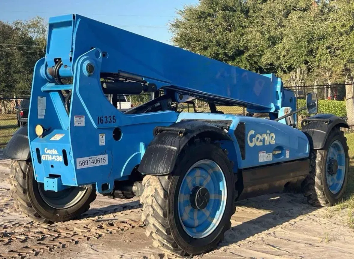 Blue Genie telehandler on a dirt surface.