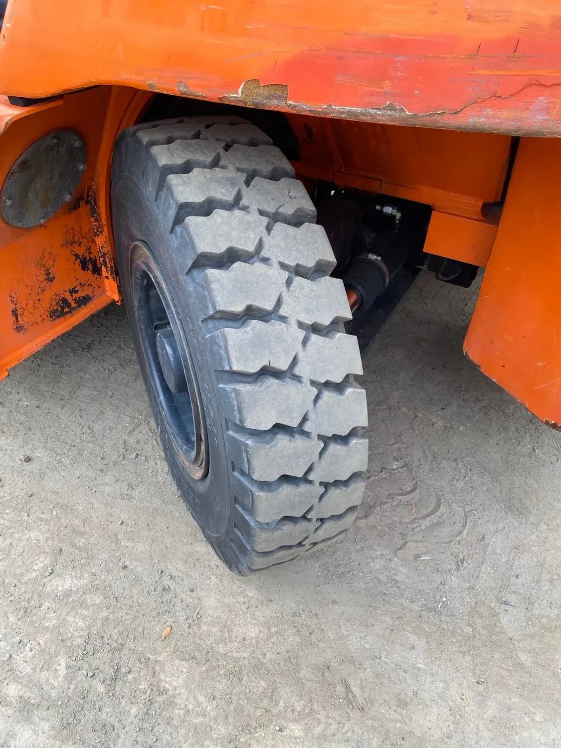 Orange vehicle tire with black rim.