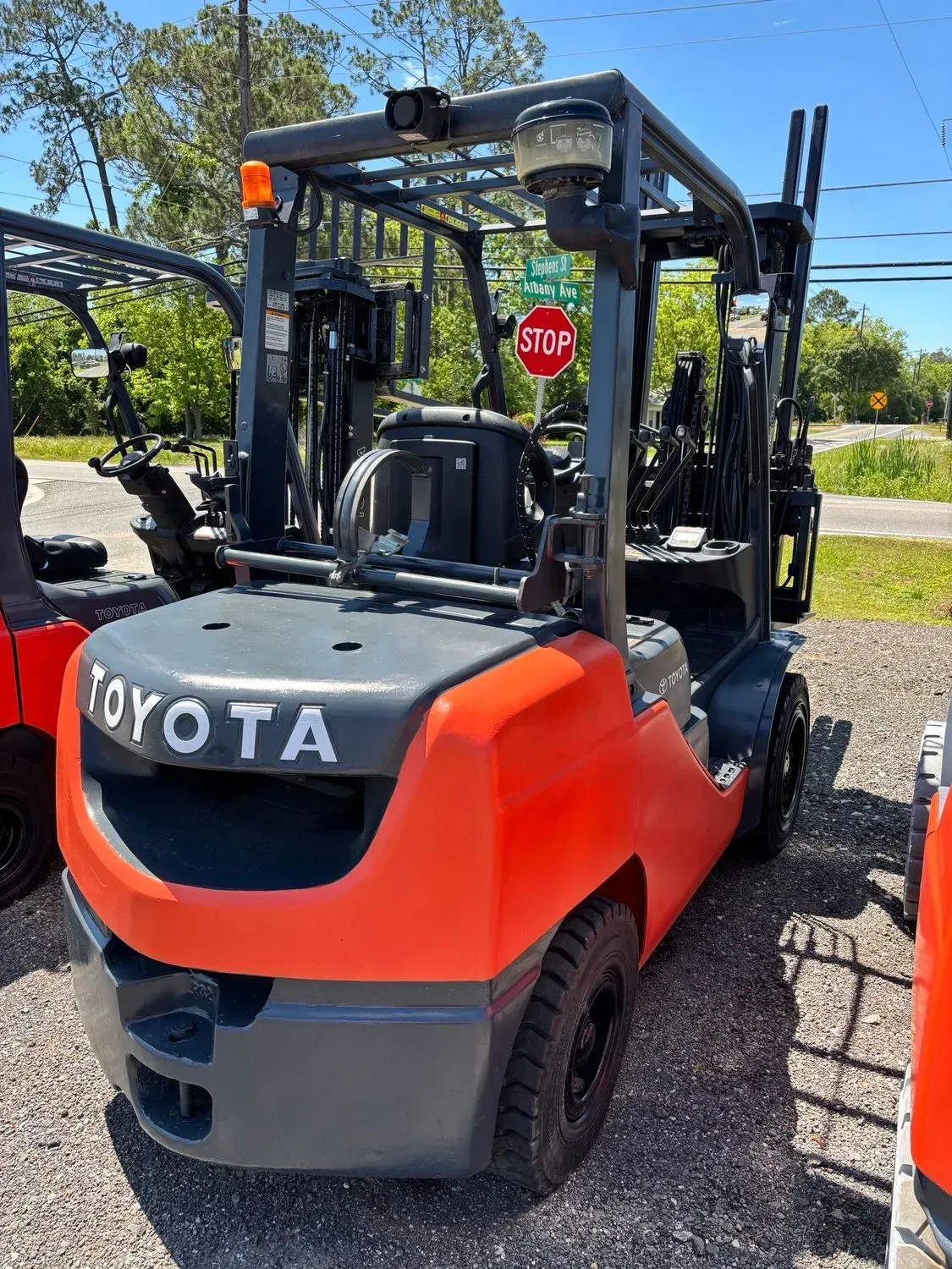 Red and gray Toyota forklift outdoors.