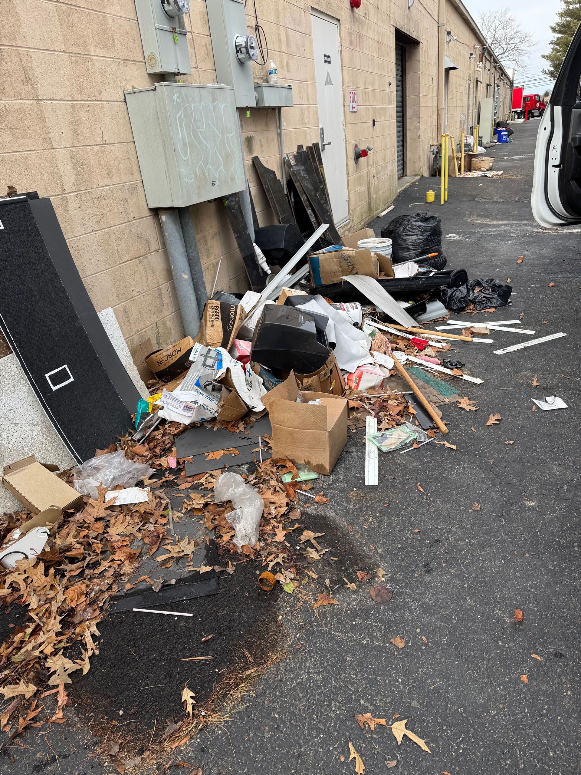 There is a lot of trash on the side of the road.