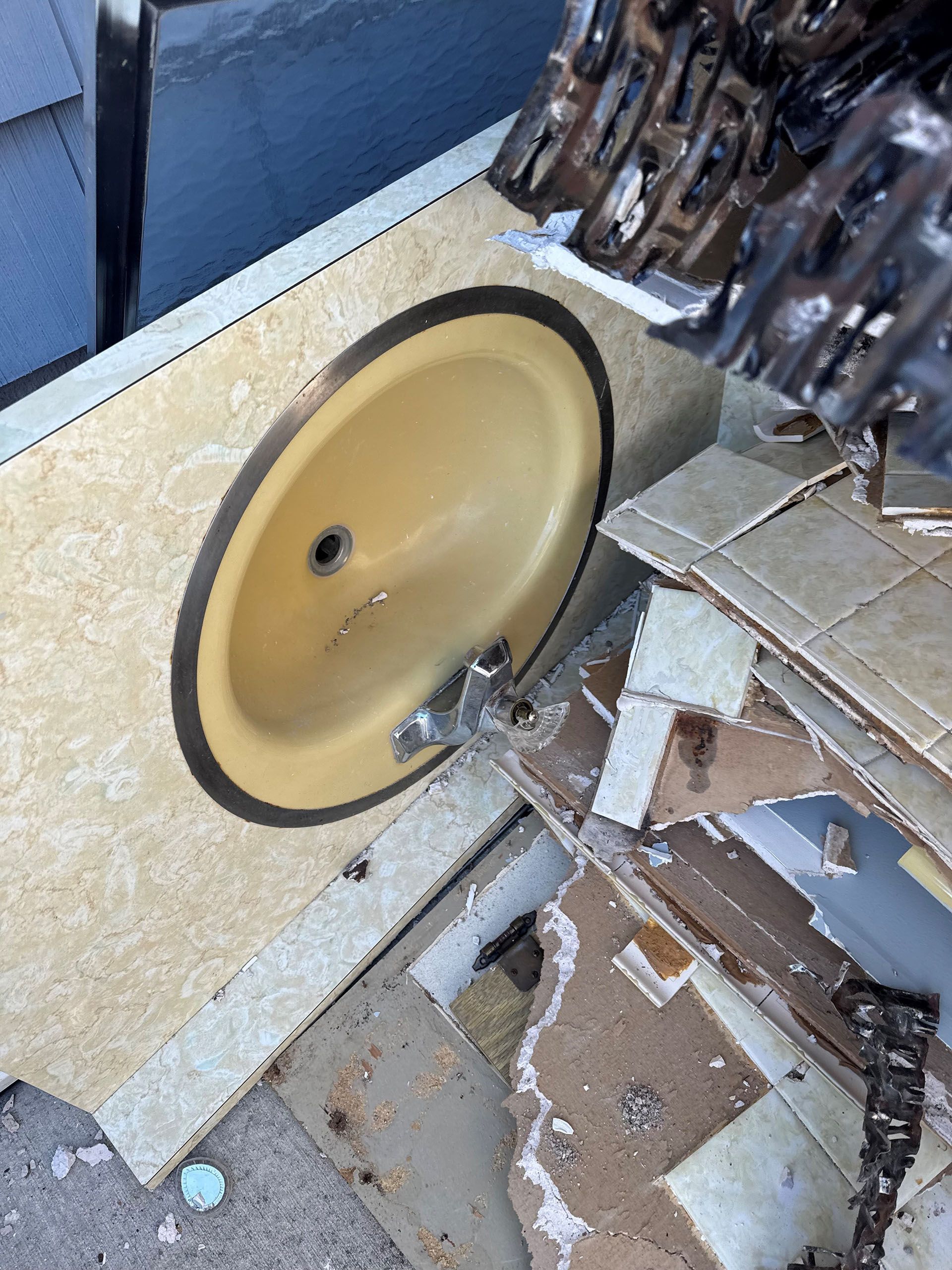 A yellow sink is sitting on top of a pile of cardboard.