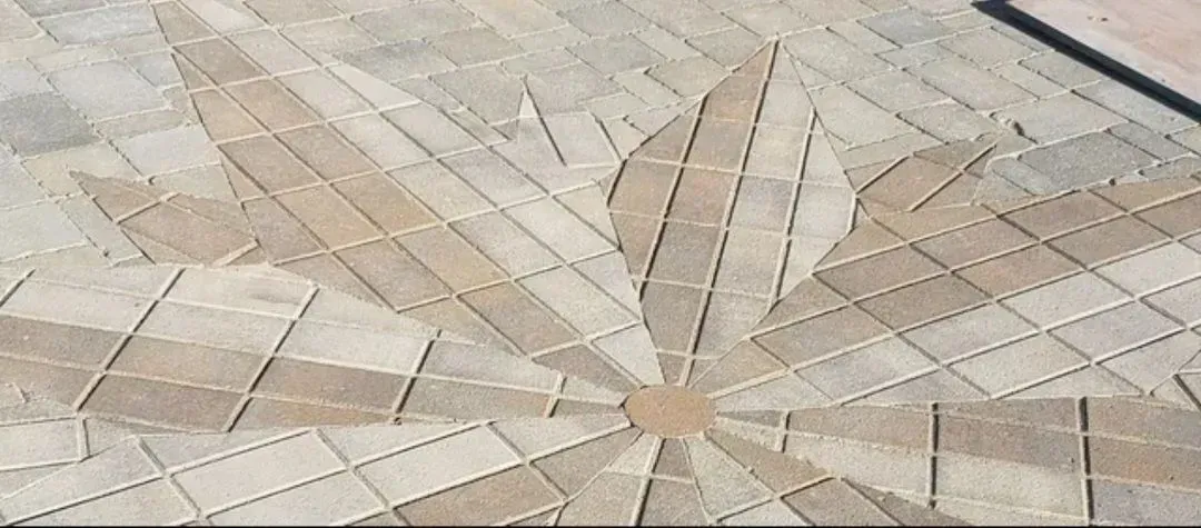 A close up of a circular pattern on a brick floor.