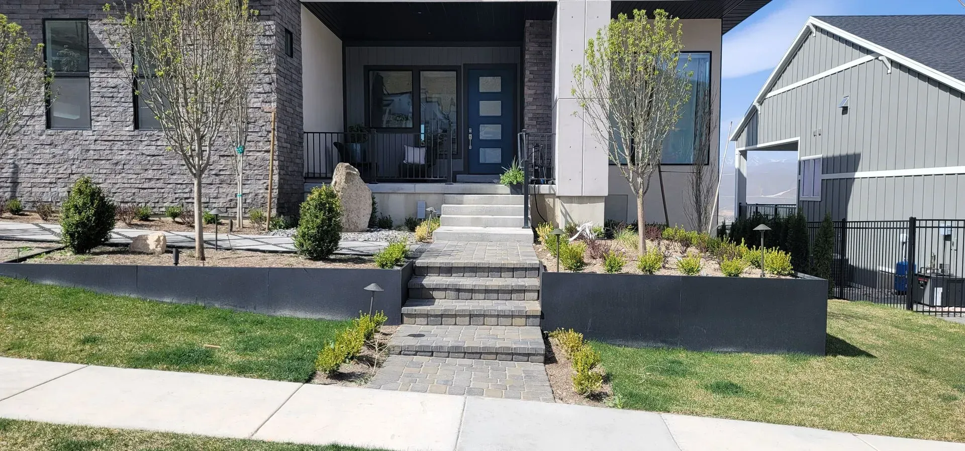 A house with a walkway leading to the front door and stairs.