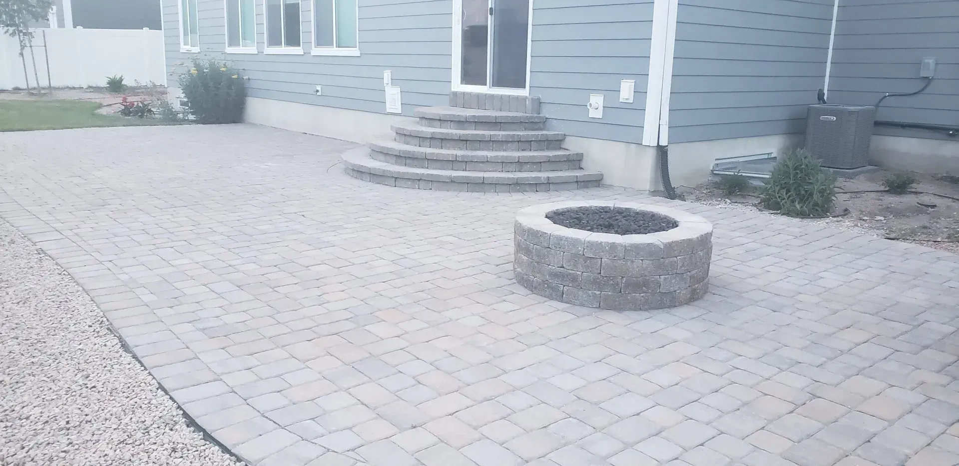 There is a fire pit in the middle of the patio.