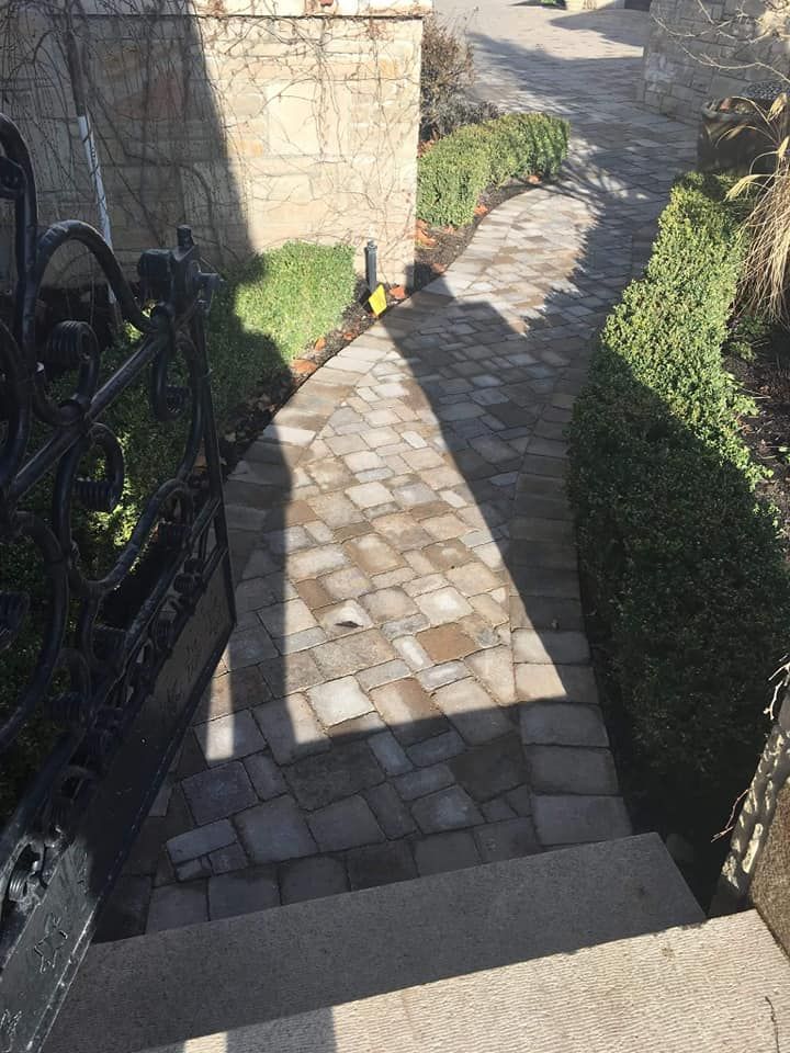 A stone walkway with stairs leading up to a house.
