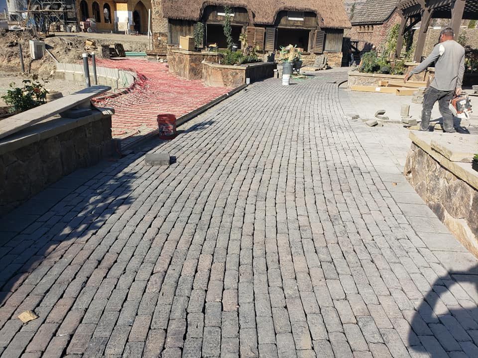A brick walkway is being built in front of a building