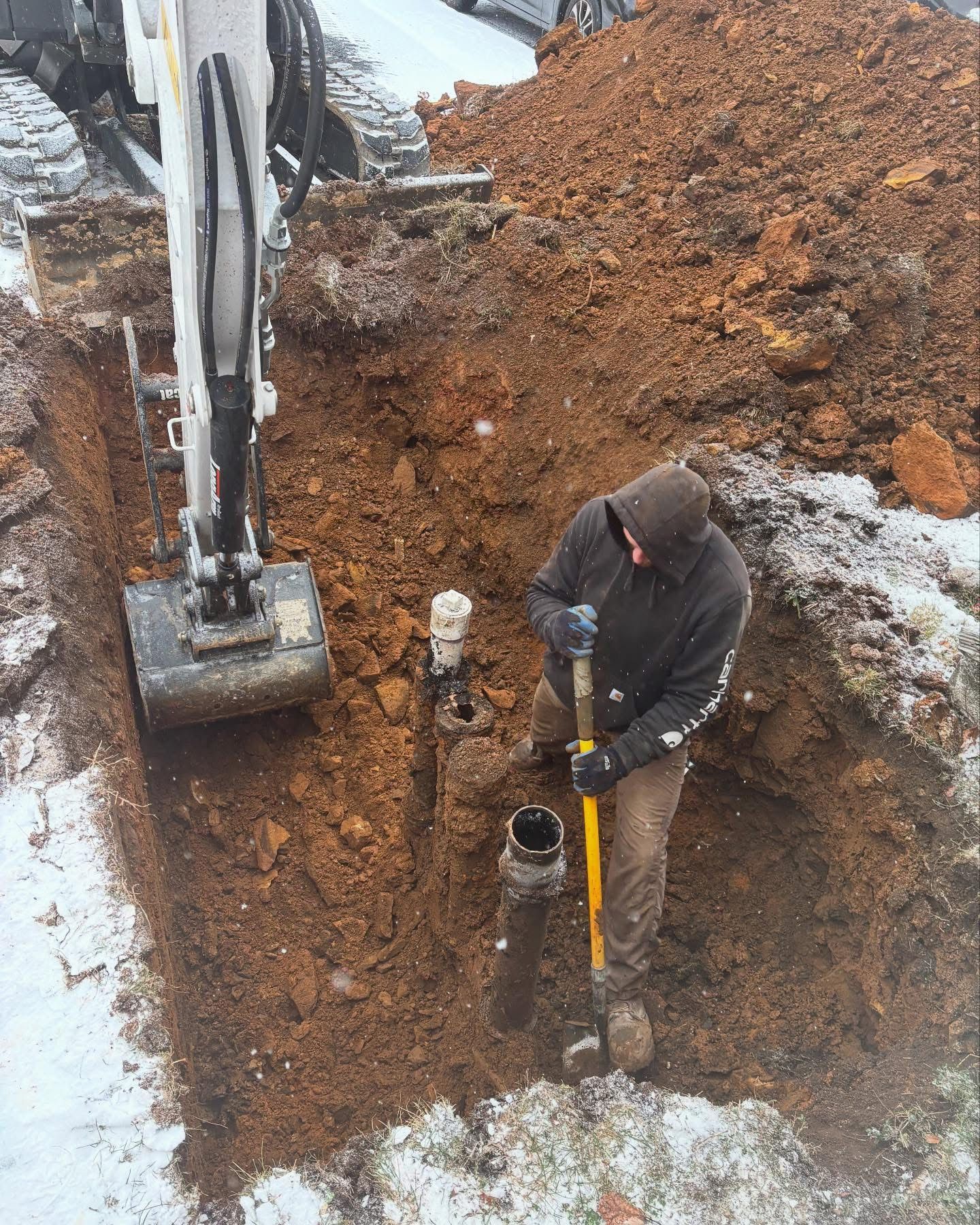 A man is digging a hole in the ground with a shovel
