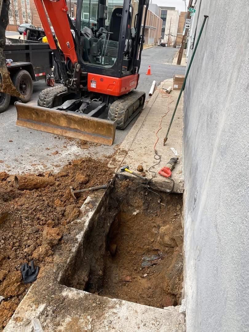 A man is digging a hole in the ground with a shovel