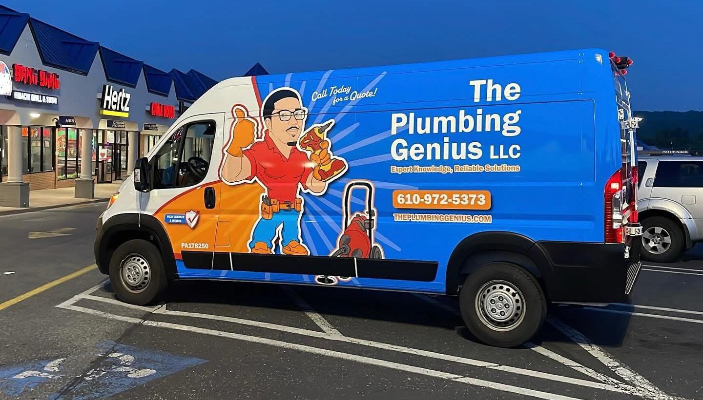 The Plumbing Genius LLC van is parked in a parking lot.