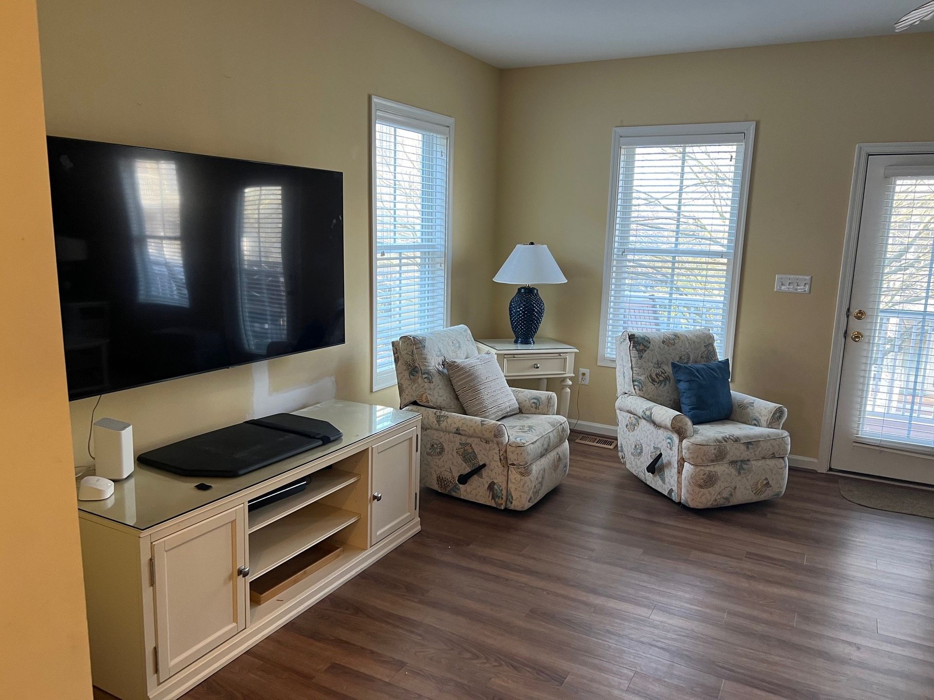 a living room with two chairs and a flat screen tv .
