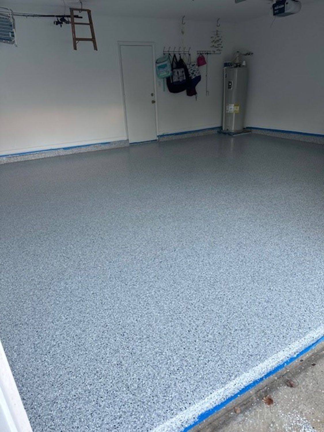 an empty room with a gray concrete floor and white walls