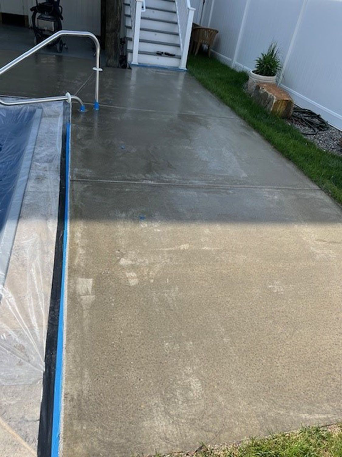 a paved path alongside a swimming pool