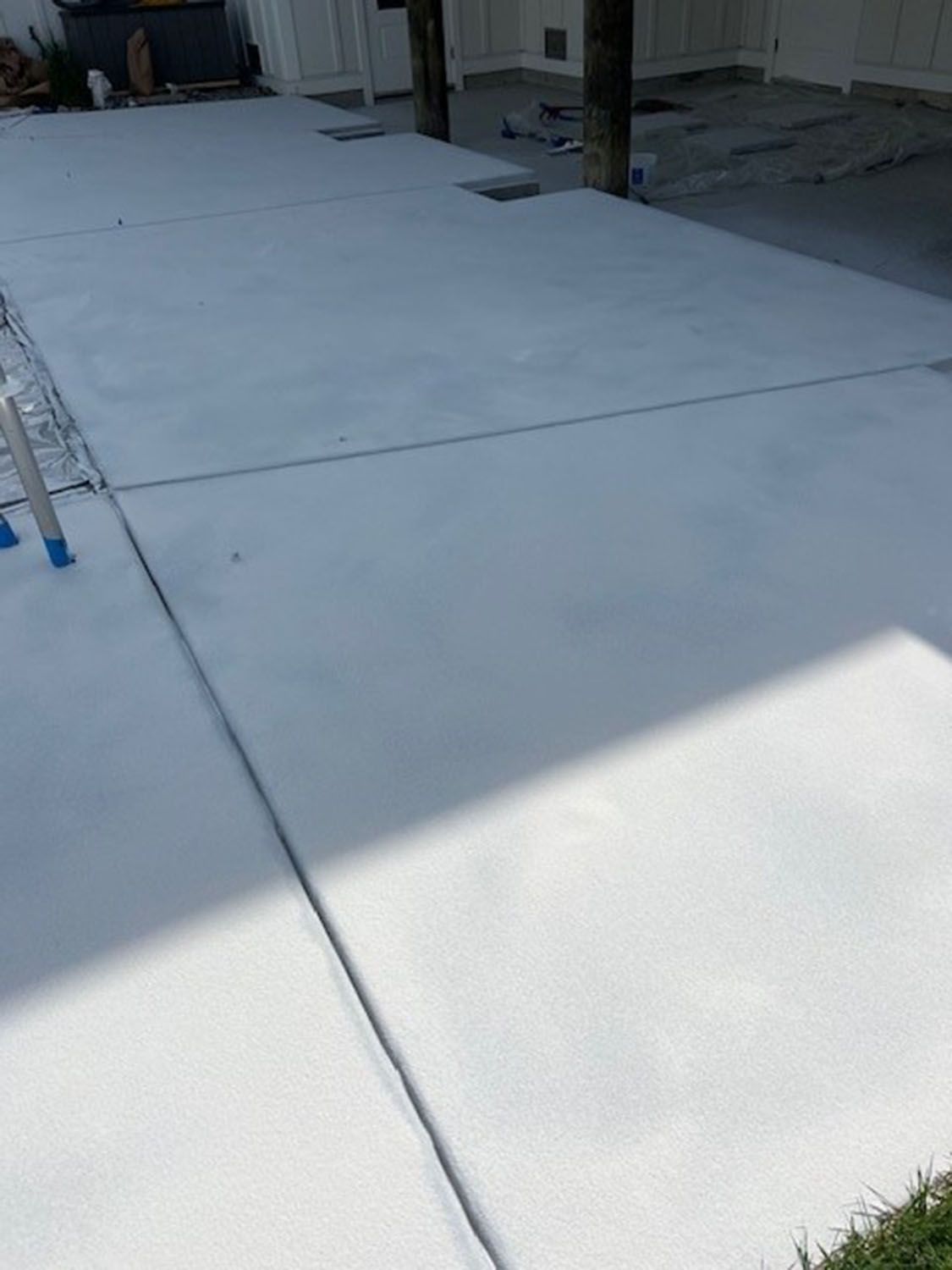 a concrete walkway next to a pool