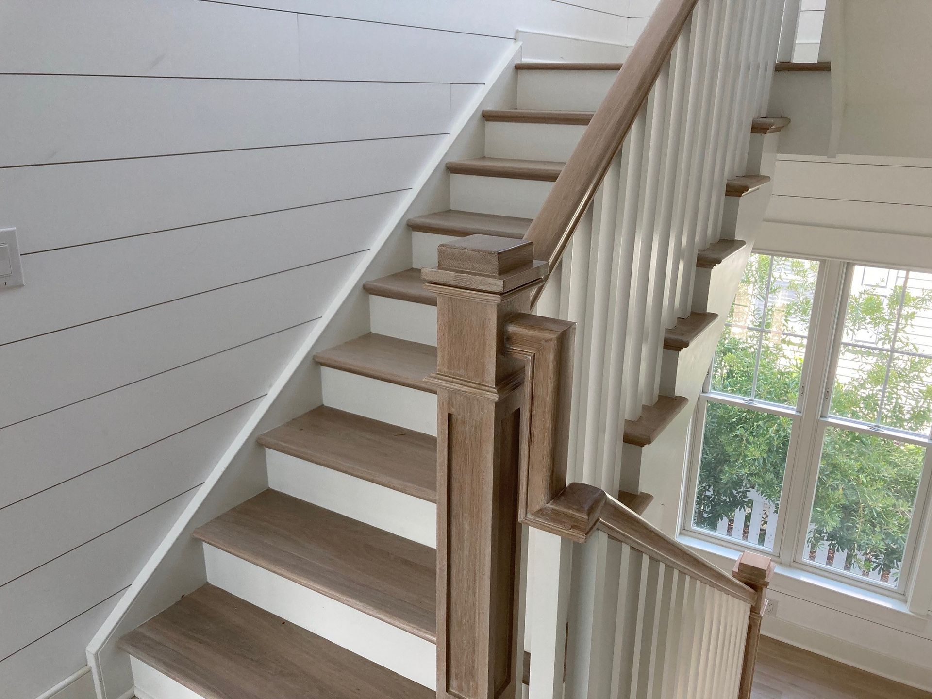 a staircase with wooden steps and a white railing
