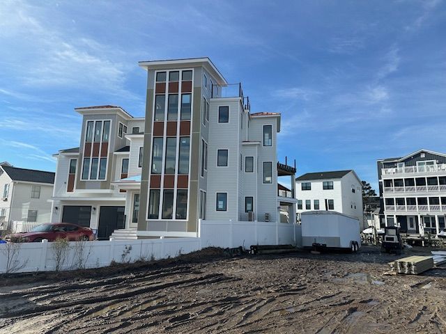 A large white building with a red car parked in front of it
