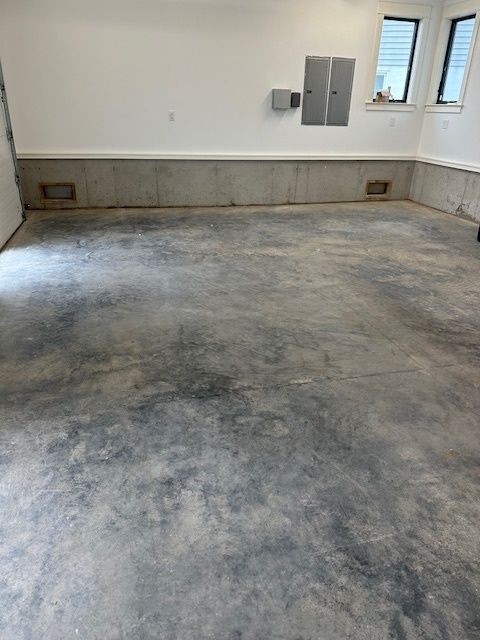 A garage with a concrete floor and white walls